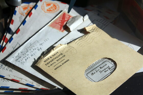 Handwritten letters and envelopes on a desk, inspiring how to write a letter to a friend