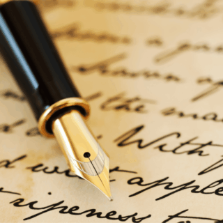 A gold-nibbed fountain pen resting on handwritten paper, illustrating 5 ways to write better in 2026