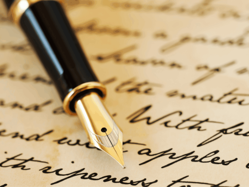 A gold-nibbed fountain pen resting on handwritten paper, illustrating 5 ways to write better in 2026