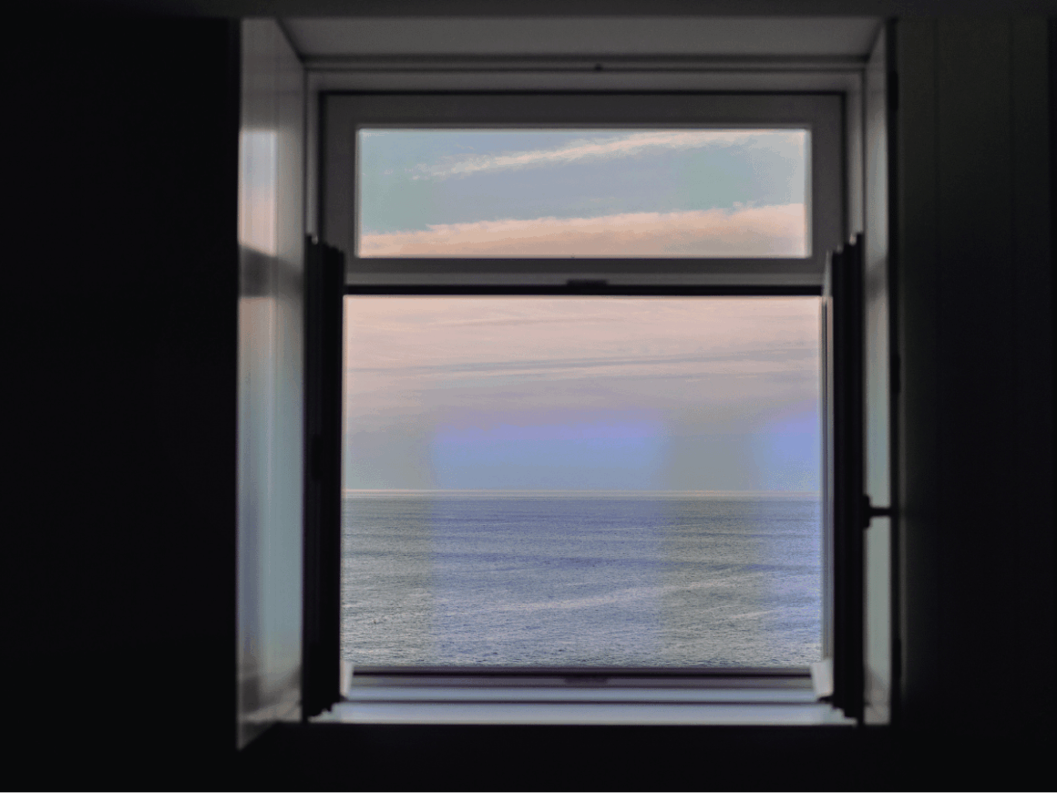 Minimalist Sustainable Lifestyle: Why Less Can Mean More Open window with ocean view symbolising clarity and a minimalist sustainable lifestyle